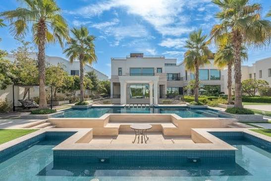 Contemporary white mansion with palm gardens and a private swimming pool